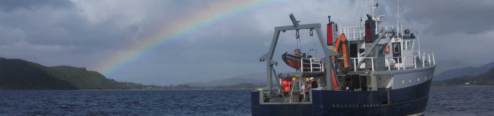 Image of SAMS research vessel with rainbow behind